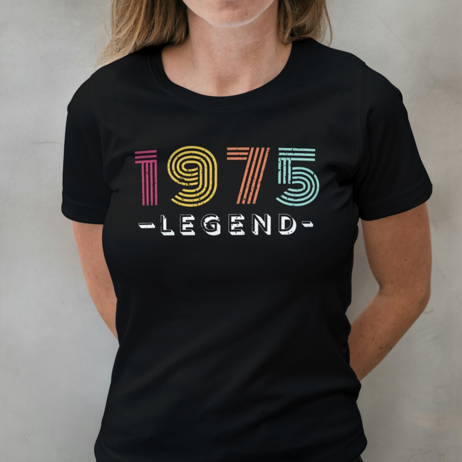 Woman wearing 1975 legend graphic tee