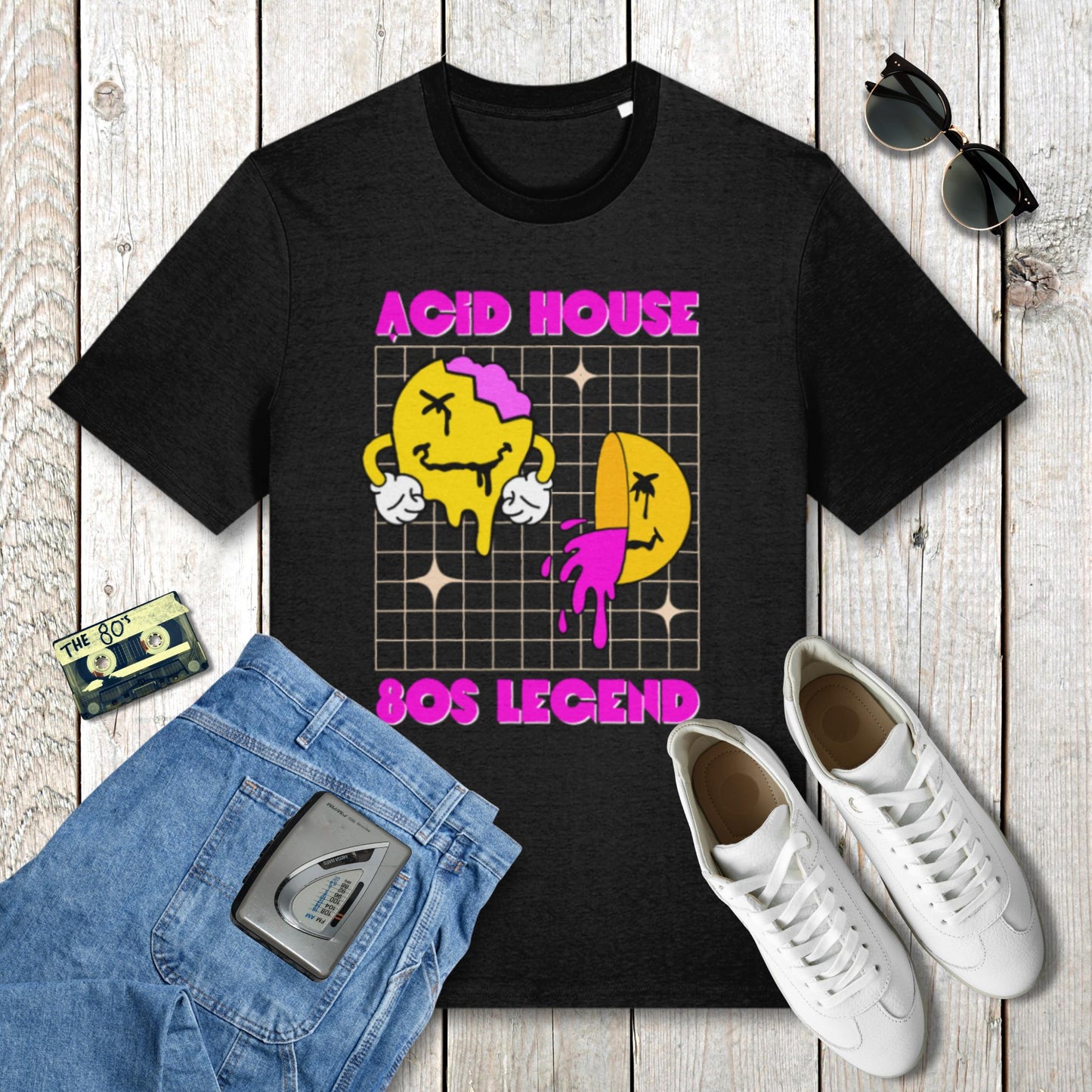 Black t-shirt with 'Acid House SOS Legend' design on a wooden surface with jeans, sneakers, and a cassette tape.