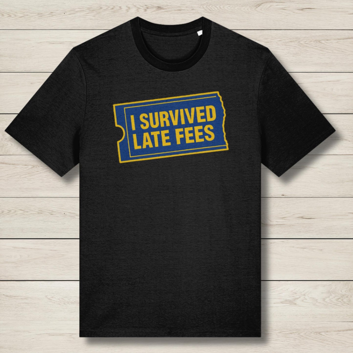 Black t-shirt with 'I Survived Late Fees' text on a wooden surface