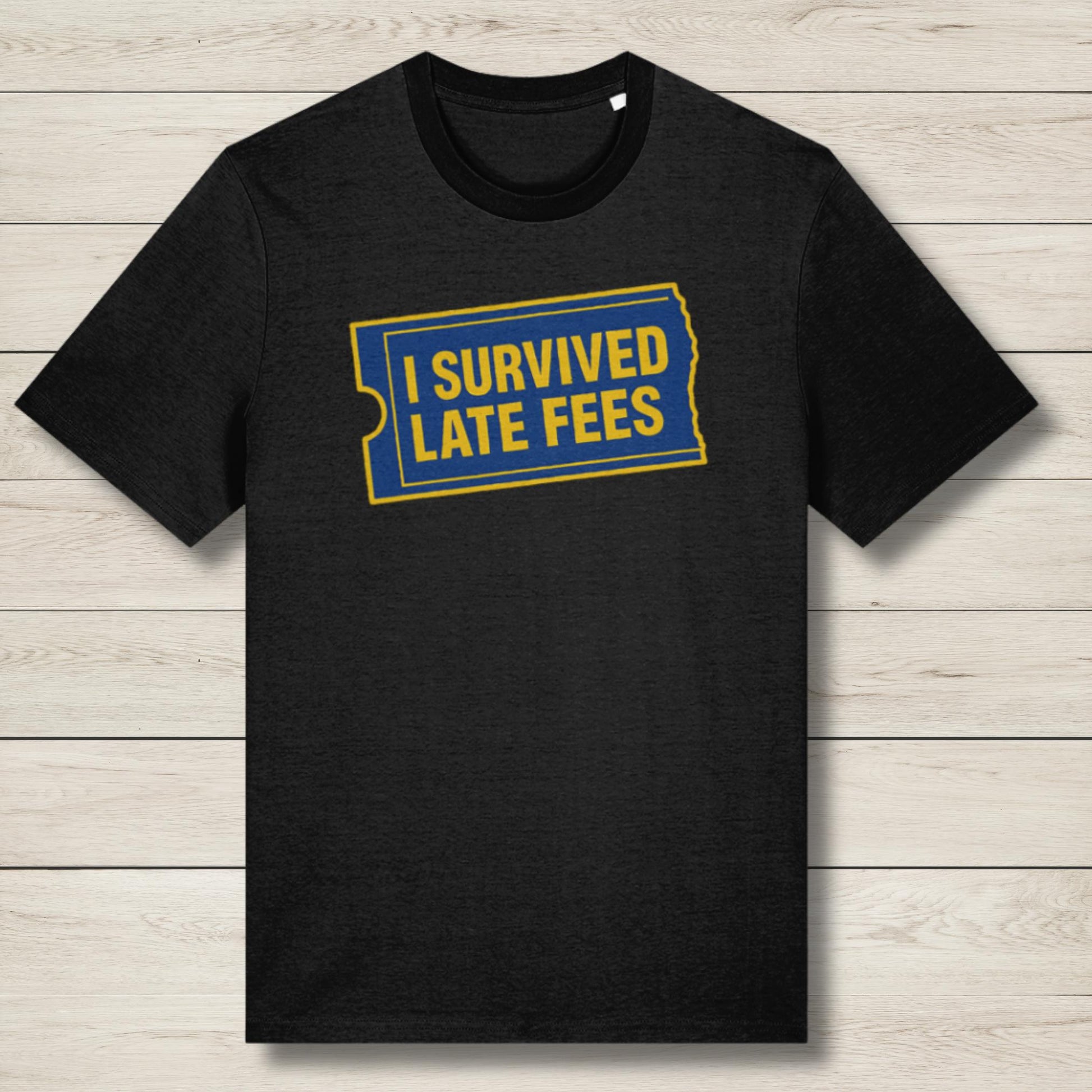 Black t-shirt with 'I Survived Late Fees' text on a wooden surface