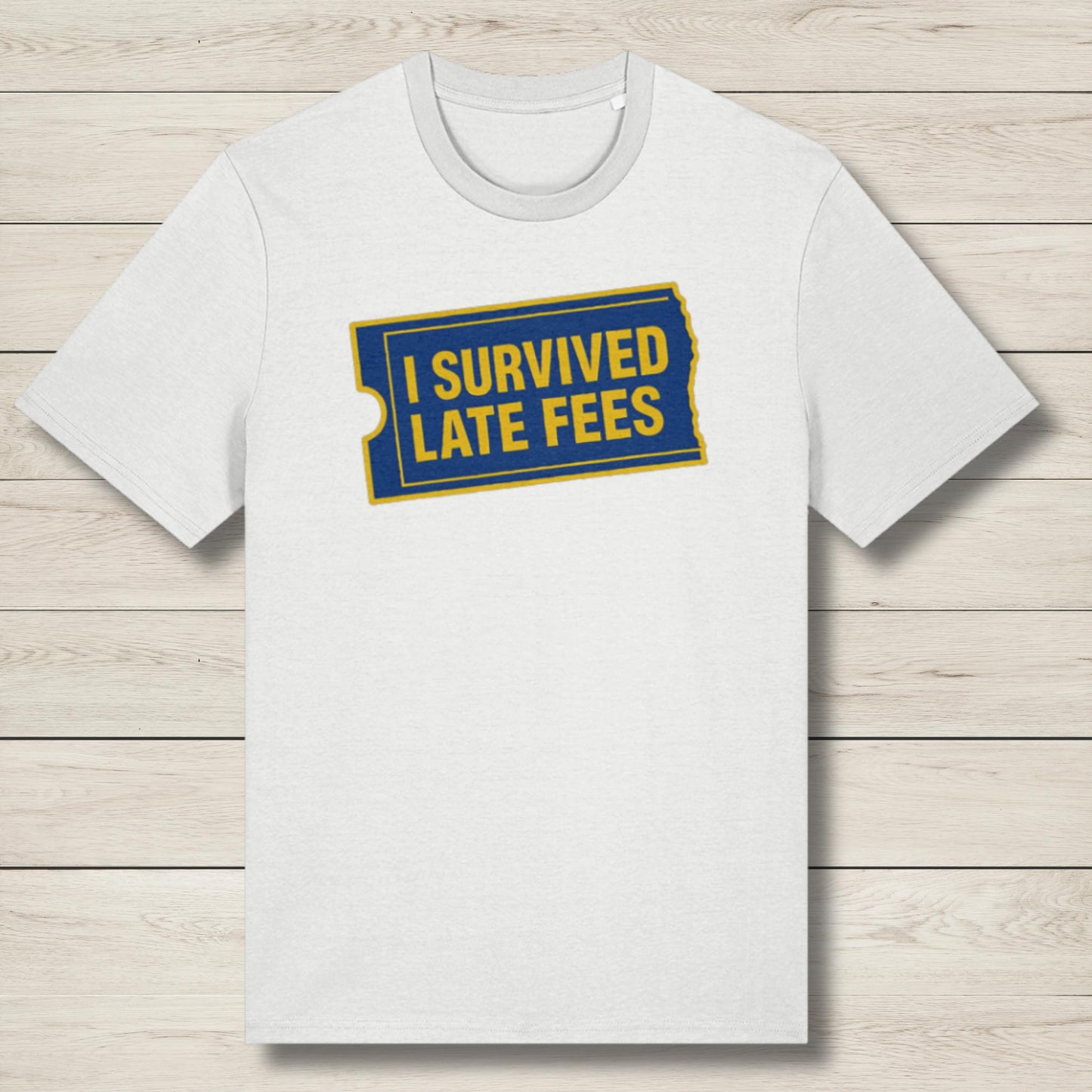 White t-shirt with 'I Survived Late Fees' text on a wooden surface
