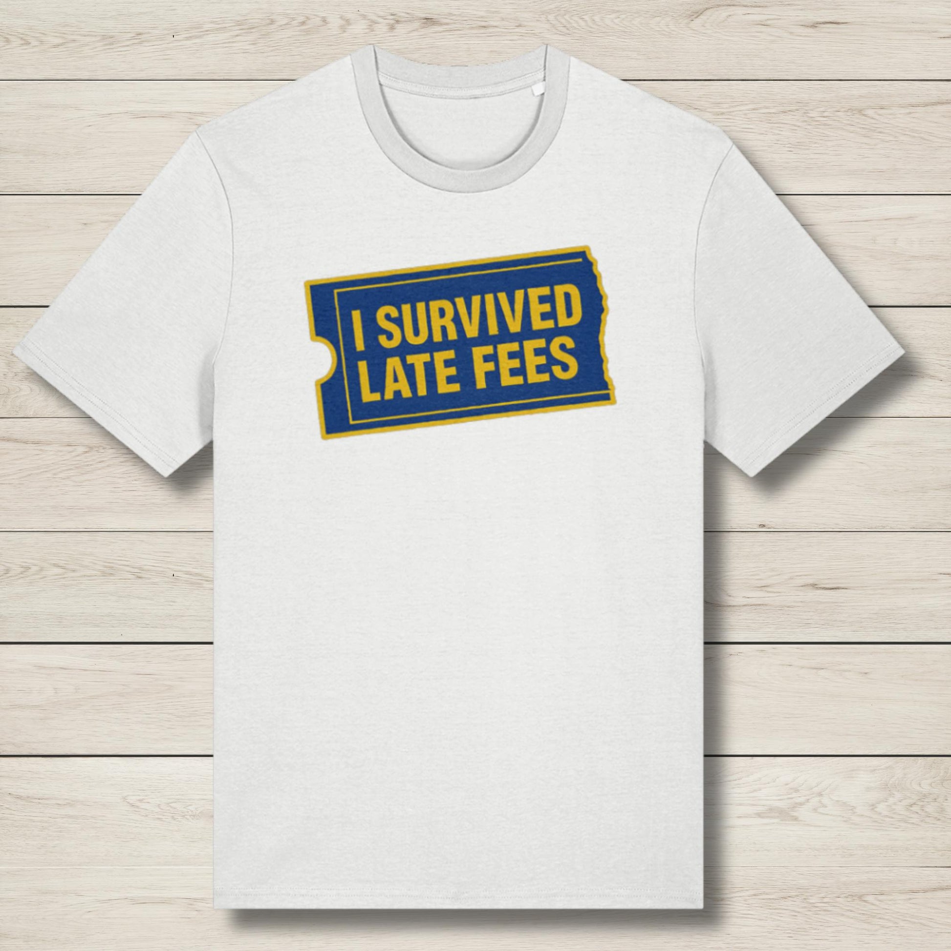 White t-shirt with 'I Survived Late Fees' text on a wooden surface