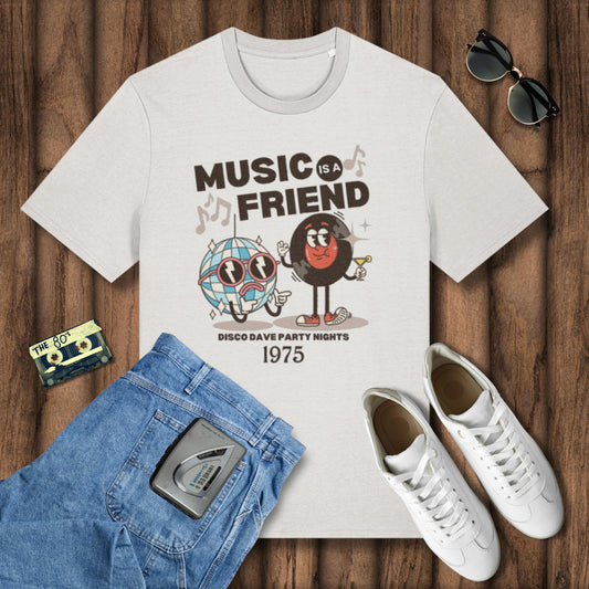 White t-shirt with 'Music is a Friend' design on a wooden surface with jeans, sneakers, and sunglasses.