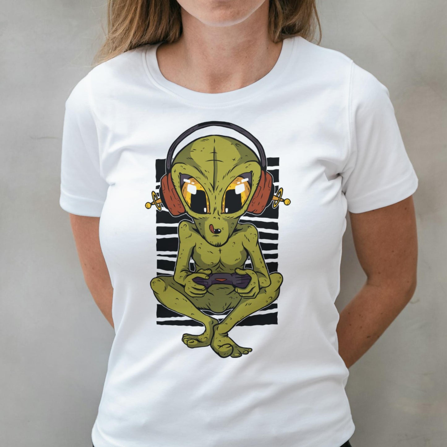 Person wearing a white t-shirt with an alien graphic design.