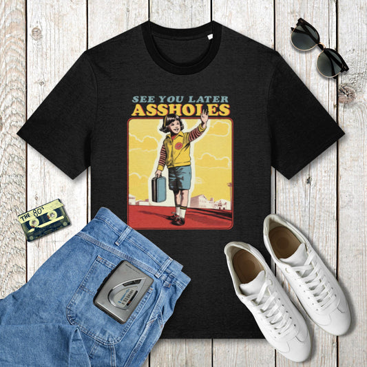Black t-shirt with graphic design and casual clothing items on a wooden surface