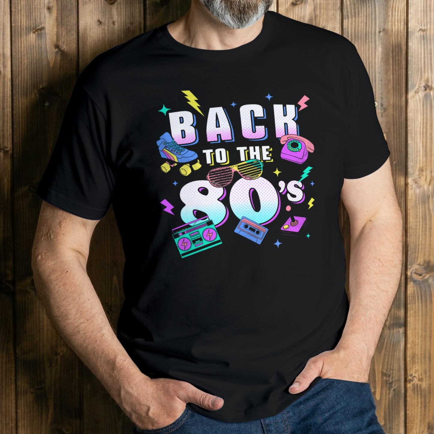 man wearing a black t-shirt with 'Back to the 80's' design against a wooden background
