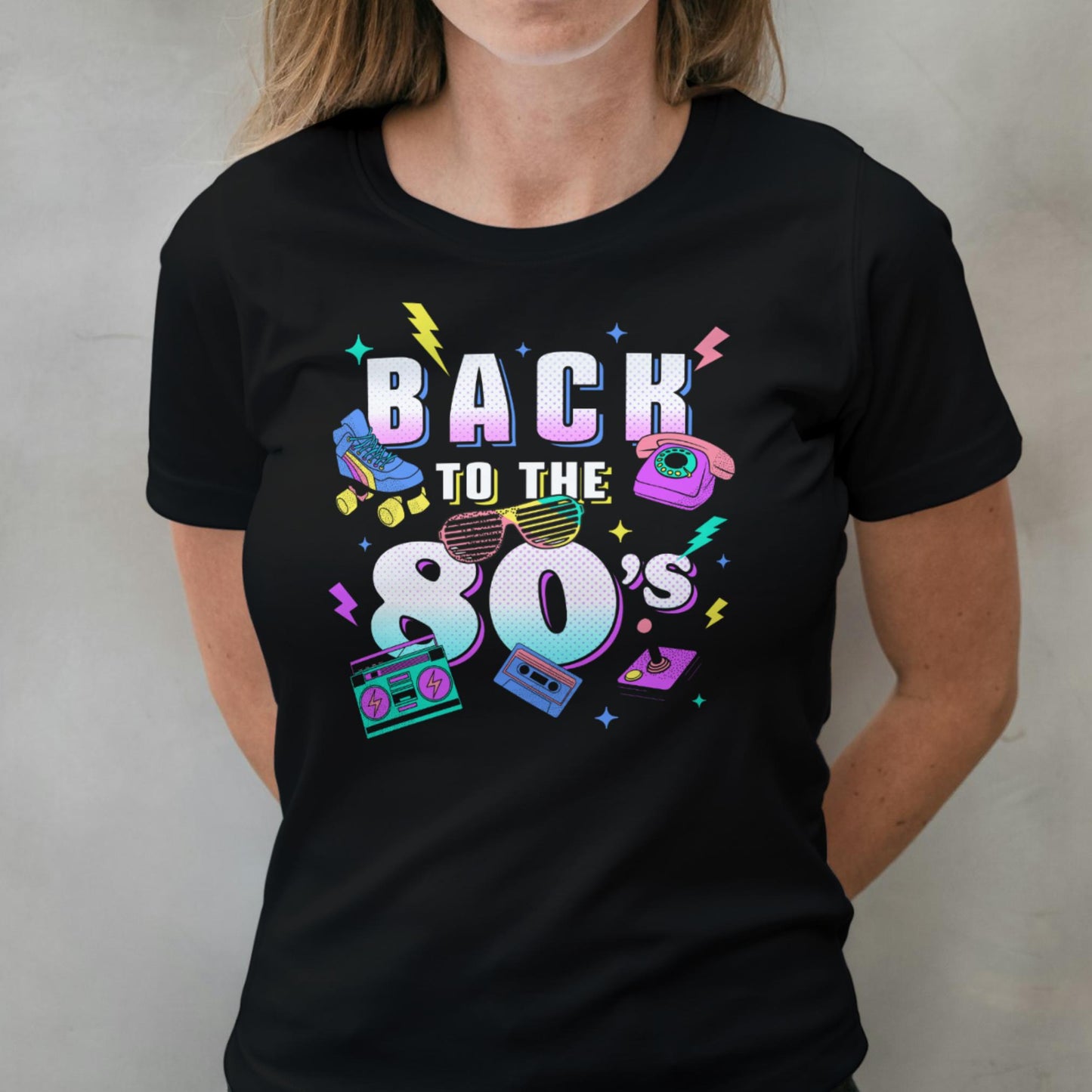 woman wearing Black t-shirt with 'Back to the 80's' design featuring retro elements on a plain background.