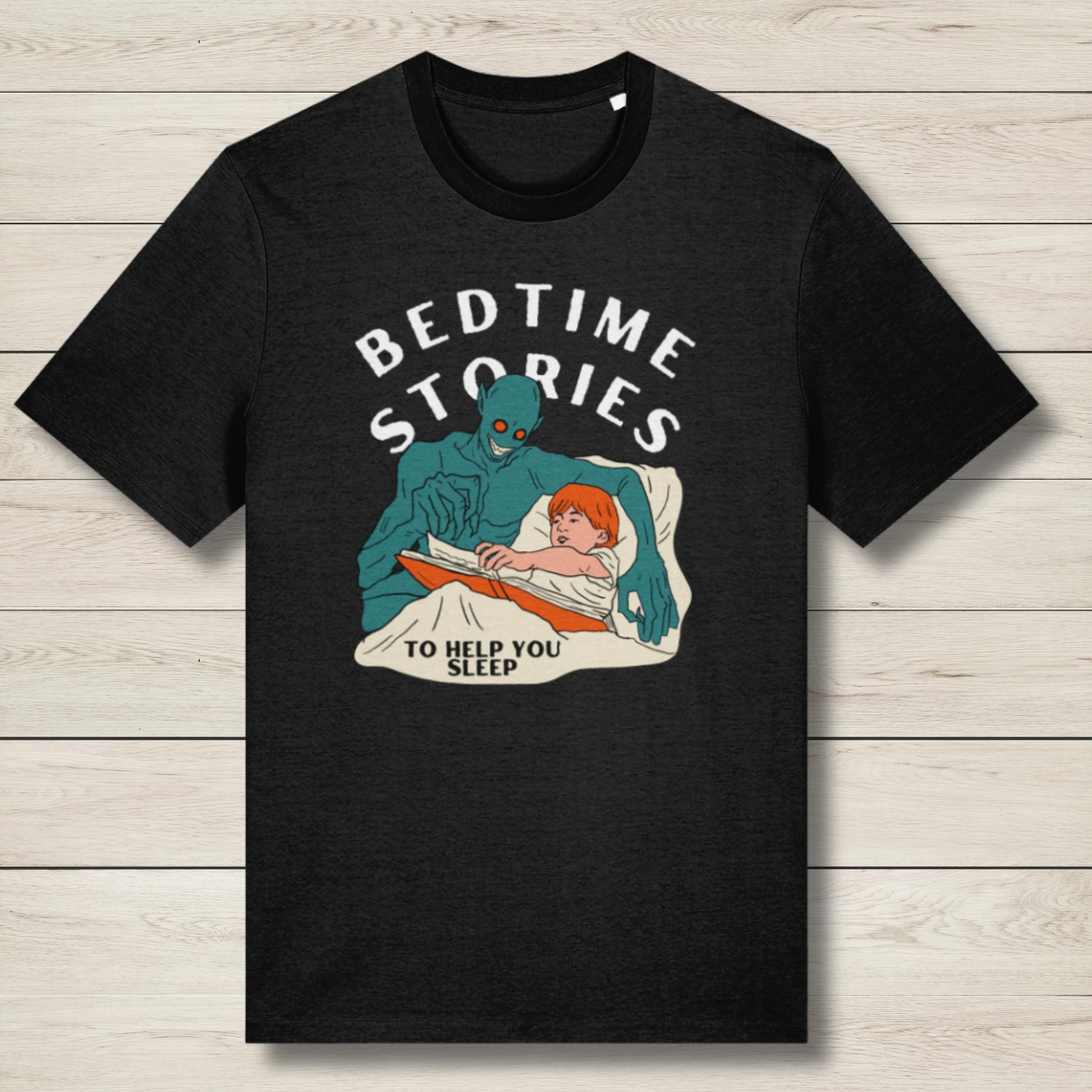 Black t-shirt with graphic of a creature reading to a child and text 'Bedtime Stories to Help You Sleep' on a wooden surface.