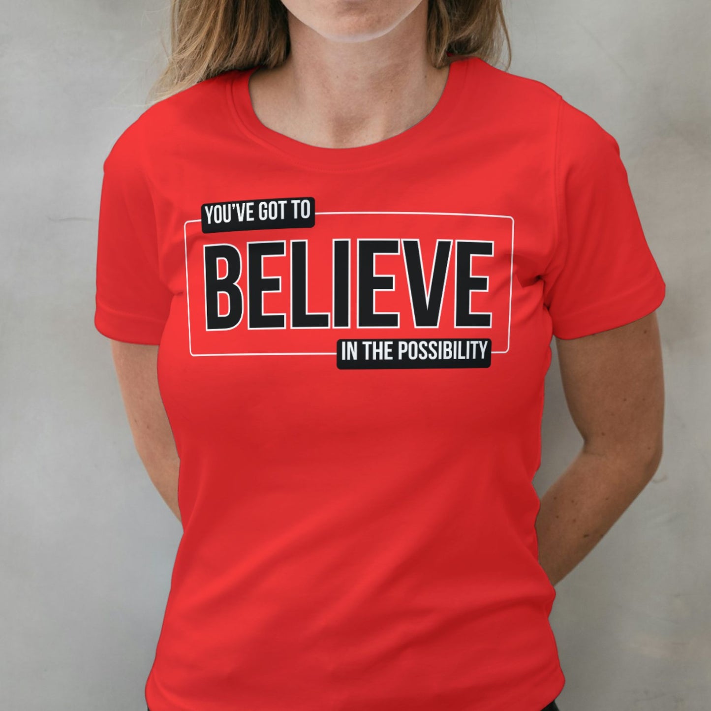 woman wearing believe red graphic tee