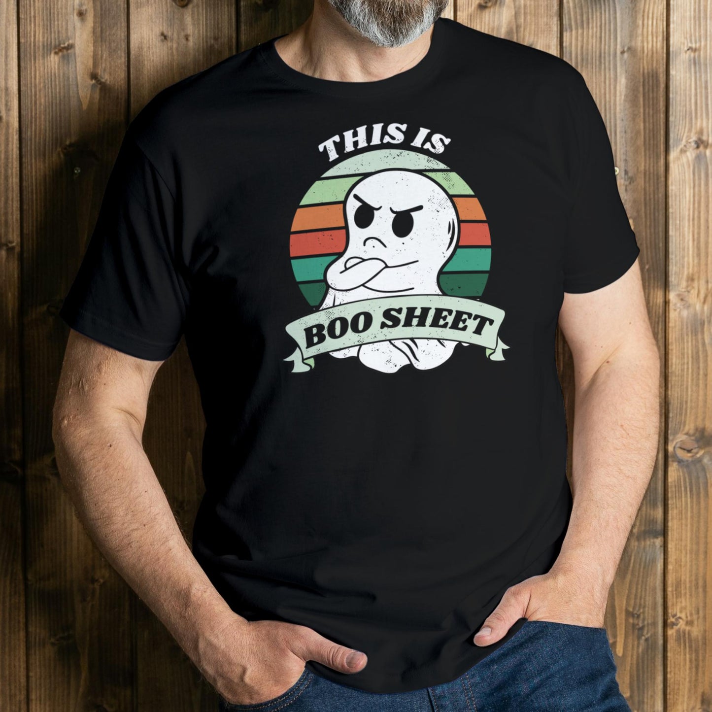 Person wearing a black t-shirt with a ghost graphic and text against a wooden background