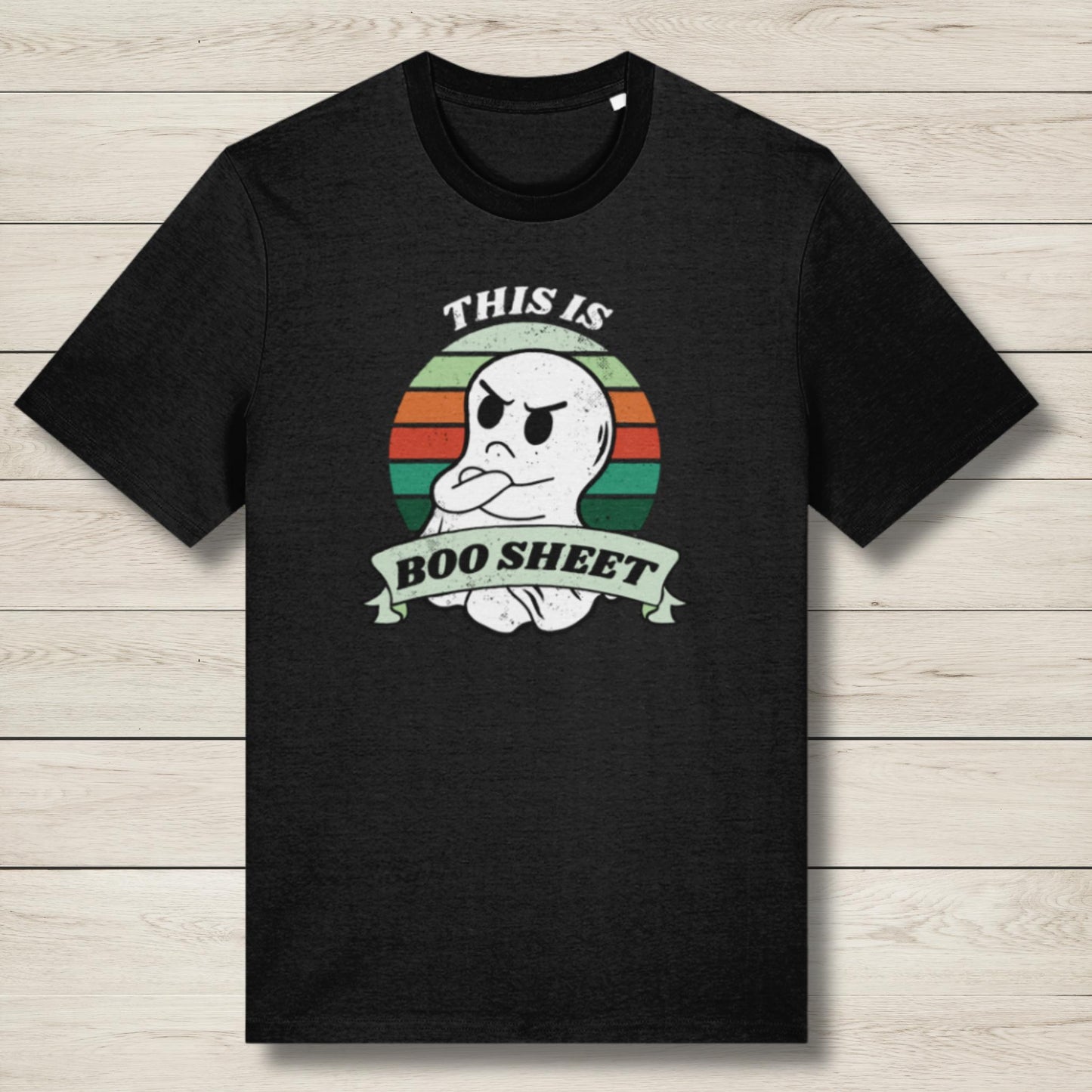 Black t-shirt with a ghost graphic and text on a wooden surface