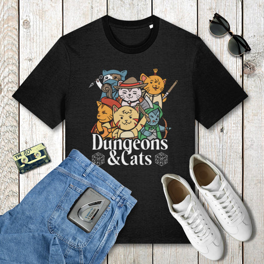 Black t-shirt with 'Dungeons & Cats' design on a wooden surface with jeans, sneakers, and sunglasses.