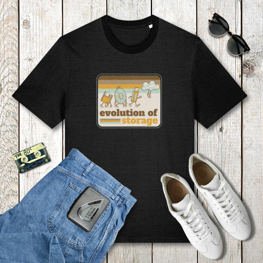 Black t-shirt with 'evolution of storage' graphic on a wooden surface with jeans, sneakers, and sunglasses.