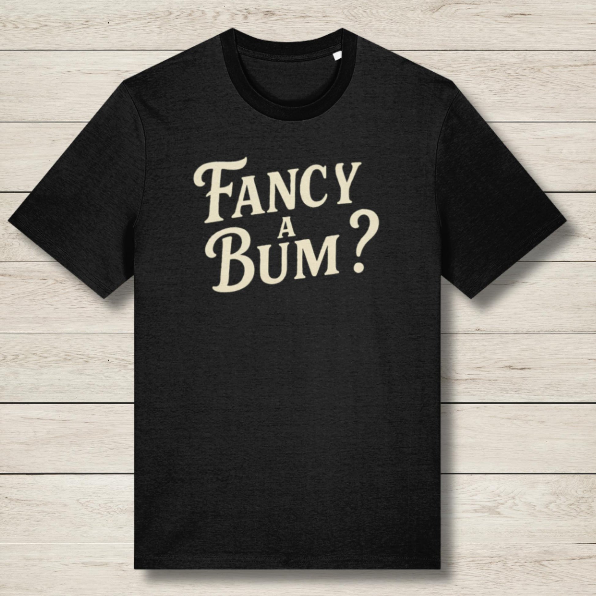 Black t-shirt with 'Fancy A Bum?' text on a wooden surface