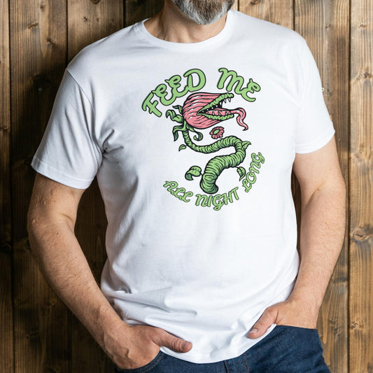 Person wearing a white t-shirt with a graphic design and text against a wooden background