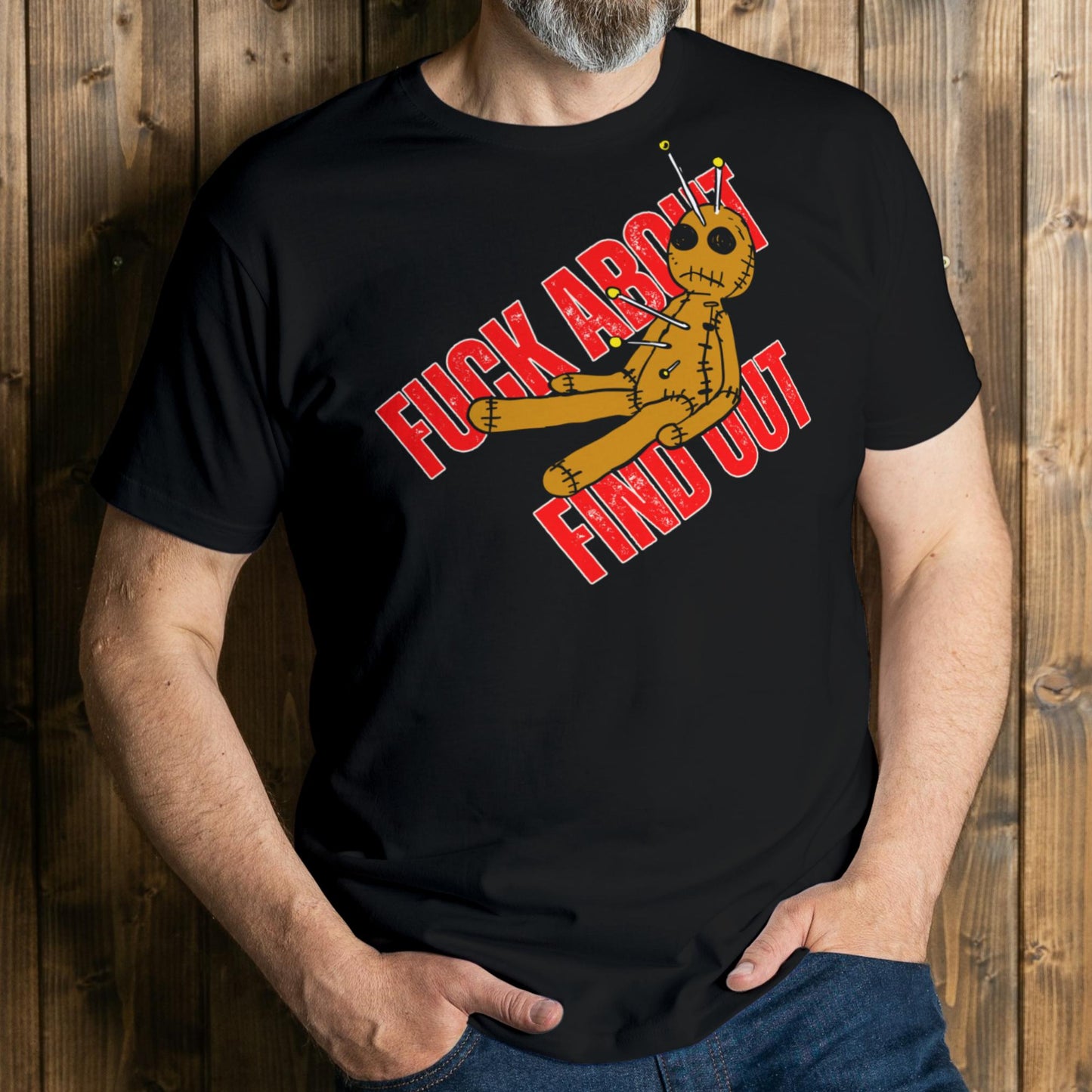 Person wearing a black t-shirt with a graphic design and text against a wooden background