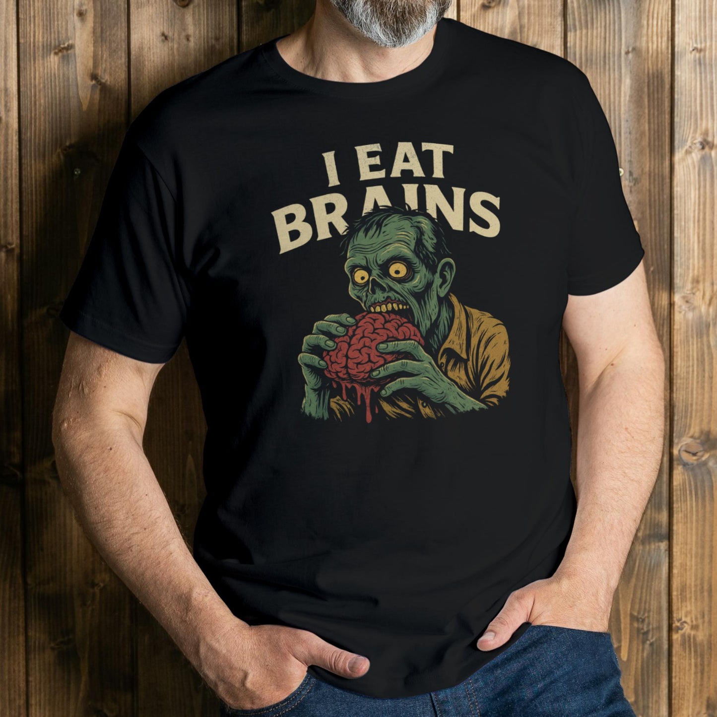 Person wearing a black t-shirt with a graphic design and text 'I Eat Brains' against a wooden background