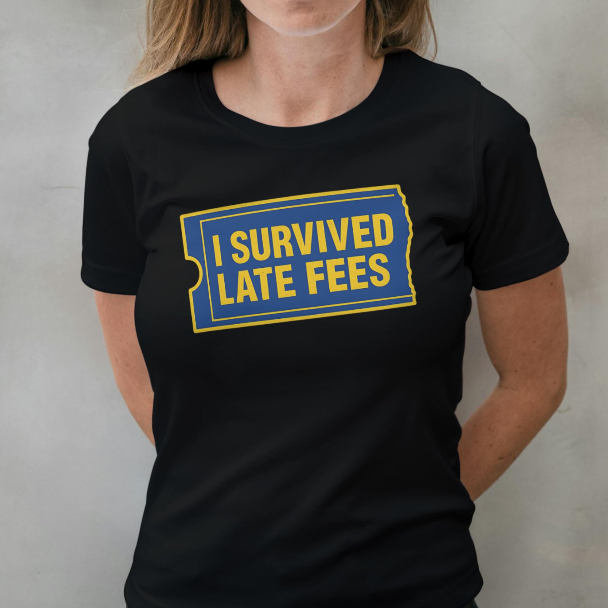 Person wearing a black t-shirt with 'I Survived Late Fees' text in yellow and blue.
