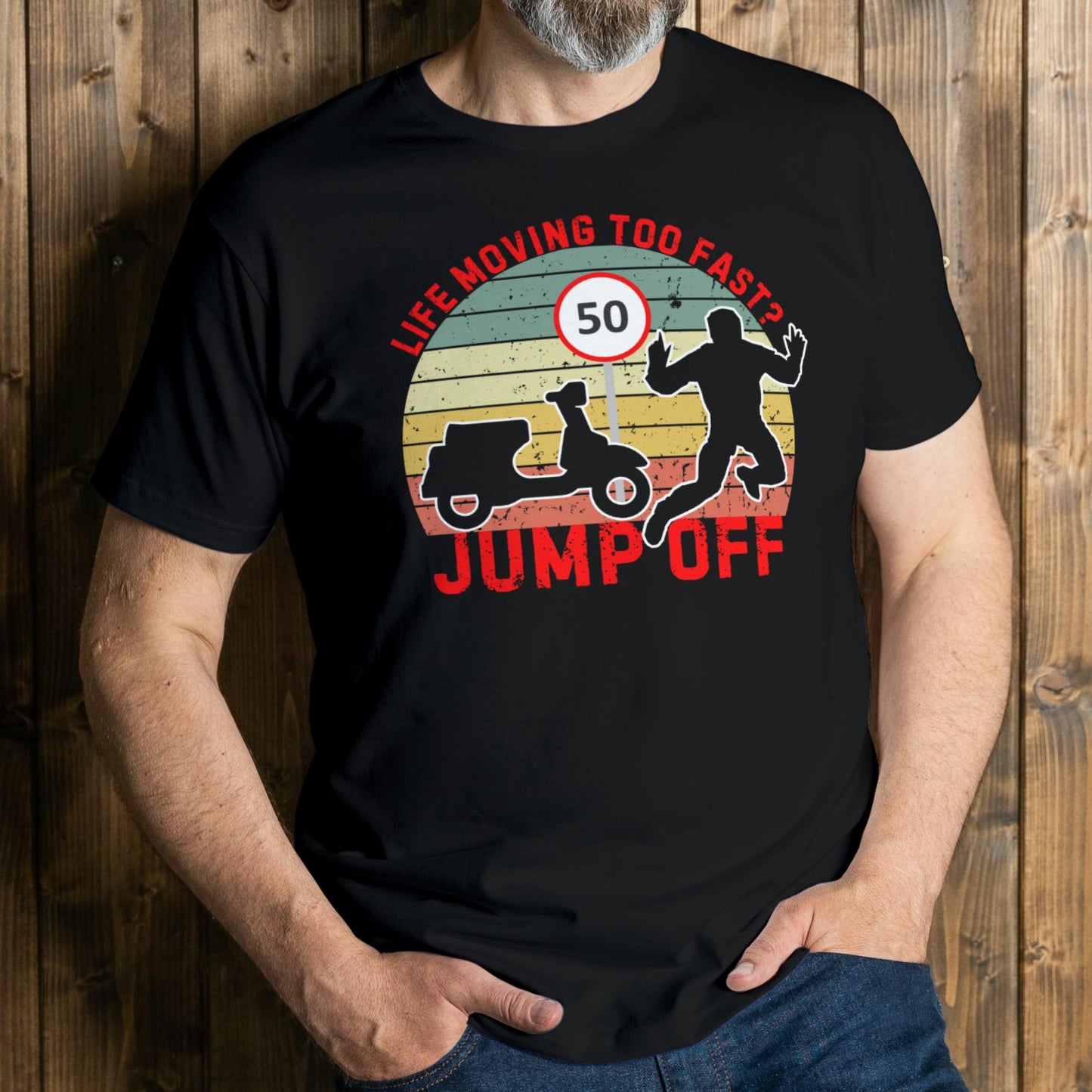 Person wearing a black t-shirt with a graphic design and text against a wooden background