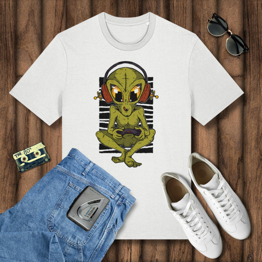 White t-shirt with alien graphic, blue shorts, white sneakers, and sunglasses on a wooden surface