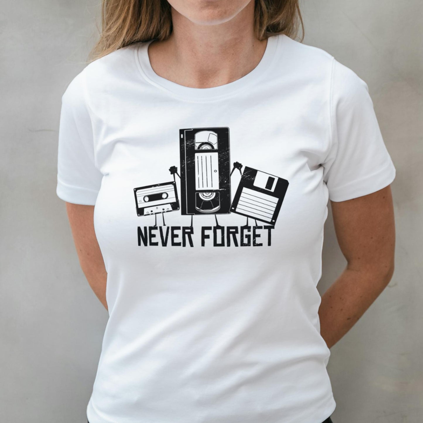 White t-shirt with 'Never Forget' graphic design featuring vintage technology icons on a plain background.