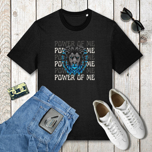 Black t-shirt with lion graphic and 'Power of Me' text on a wooden surface with jeans, sneakers, and sunglasses.