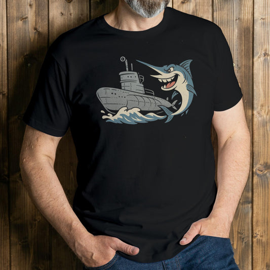 Person wearing a black t-shirt with a graphic design of a shark attacking a submarine on a wooden background