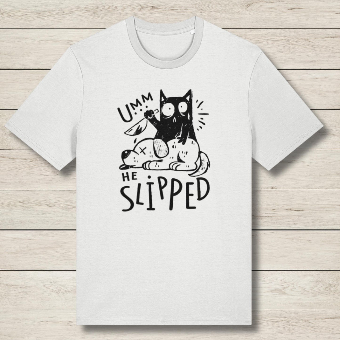 White t-shirt with a black cat graphic and text on a wooden surface