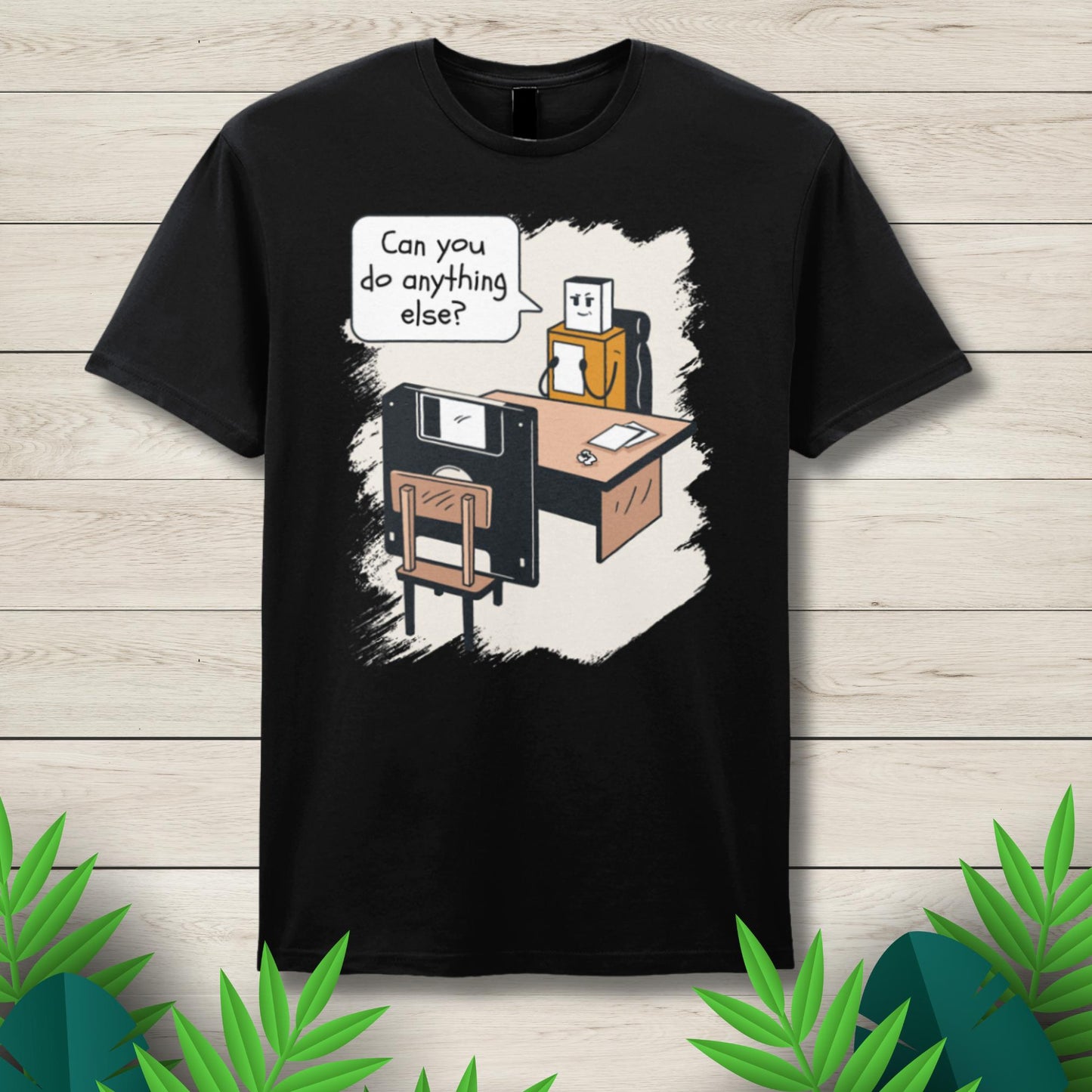 Black t-shirt with a graphic design of a robot and floppy disk on a wooden background