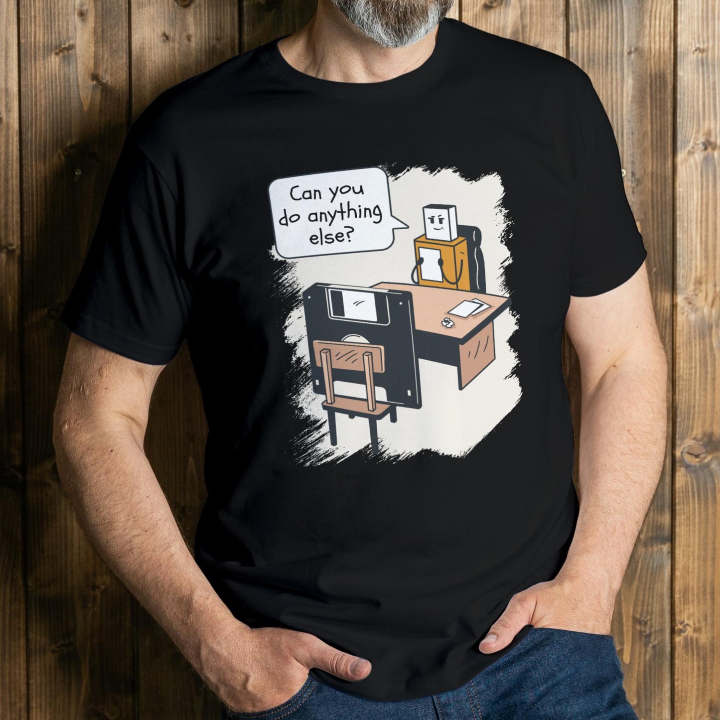 Person wearing a black t-shirt with a graphic design of a robot and text on a wooden background