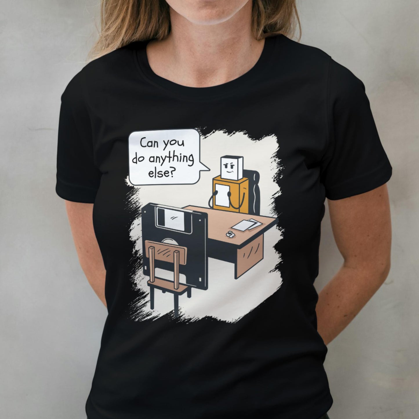 Person wearing a black t-shirt with a cartoon design on a plain background