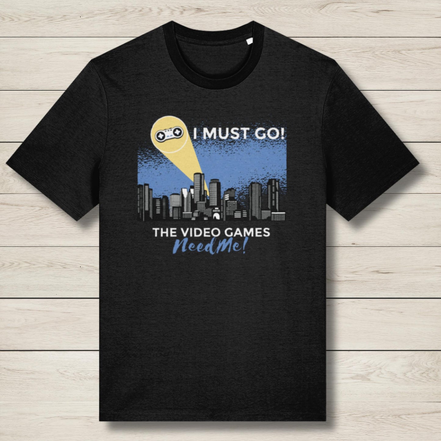 Black t-shirt with graphic design and text on a wooden surface