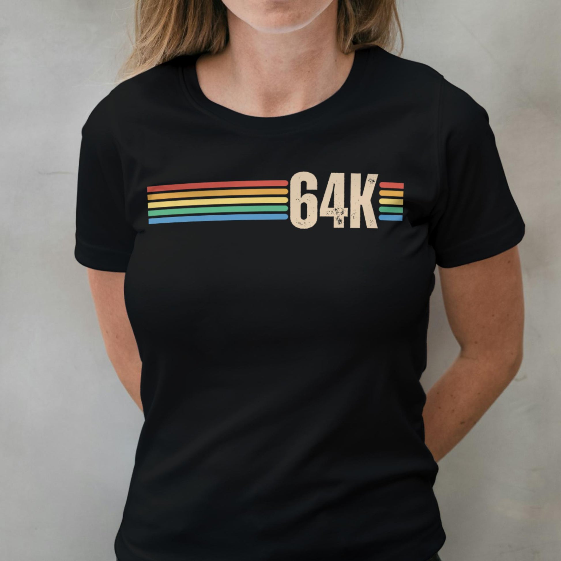 Person wearing a black t-shirt with '64K' design on a plain background