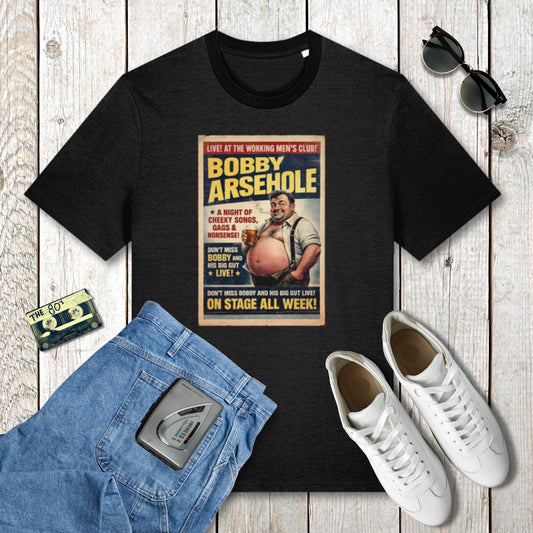 Black t-shirt with graphic design on a wooden surface with jeans, sneakers, and sunglasses.