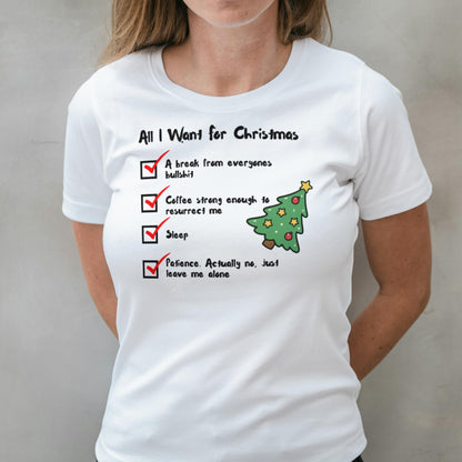 White t-shirt with Christmas-themed text and graphics worn by a person.