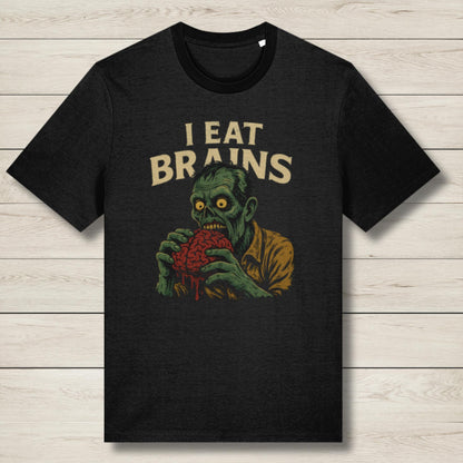 Black t-shirt with a graphic of a zombie holding a brain and 'I Eat Brains' text on a wooden surface.