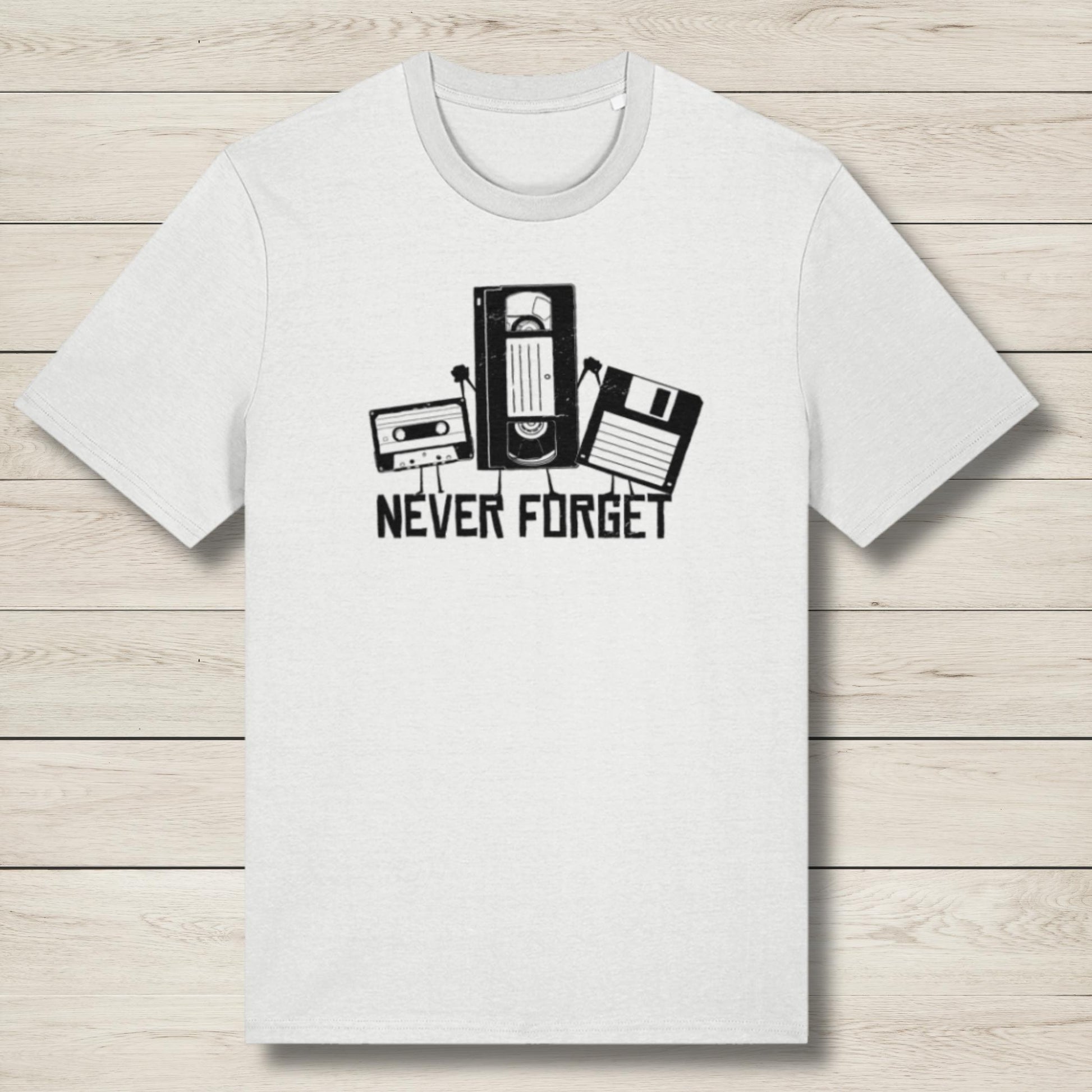 White t-shirt with retro technology graphic and 'Never Forget' text on a wooden surface