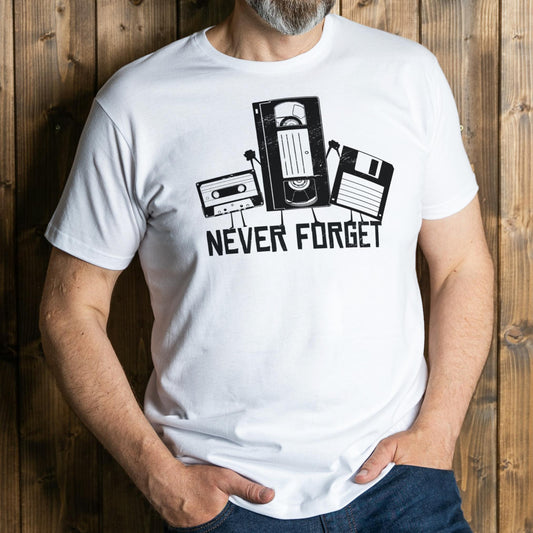 Person wearing a white t-shirt with a graphic design and text 'Never Forget' against a wooden background