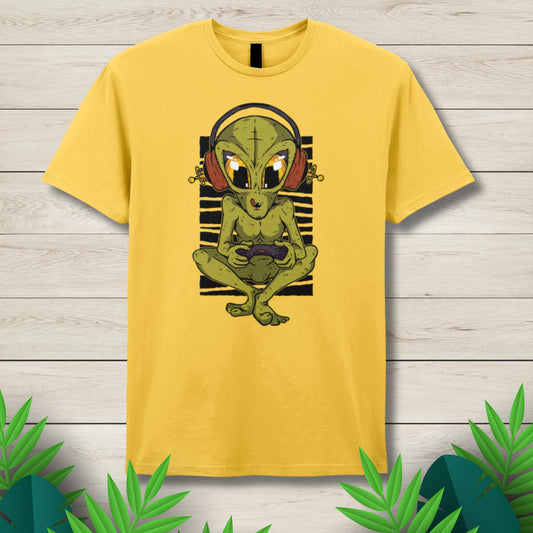 Yellow t-shirt with an alien graphic on a wooden surface
