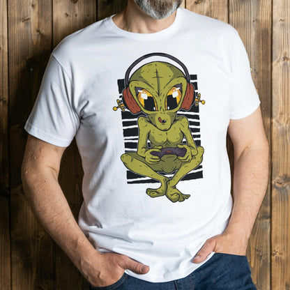 Person wearing a white t-shirt with an alien graphic design against a wooden background