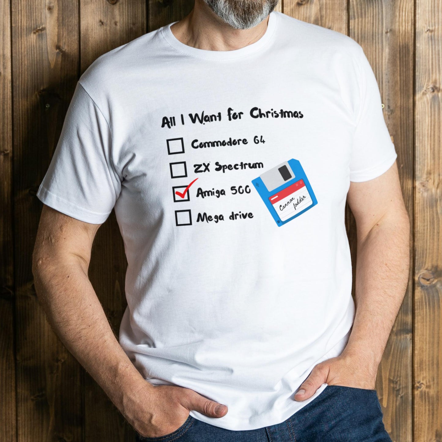 Person wearing a white t-shirt with a retro computer hardware wishlist graphic against a wooden background