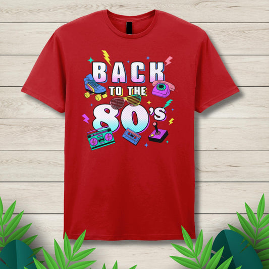 Red t-shirt with 'Back to the 80's' design on a wooden surface with decorative leaves.