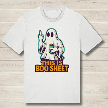 White t-shirt with a ghost graphic and text on a wooden surface