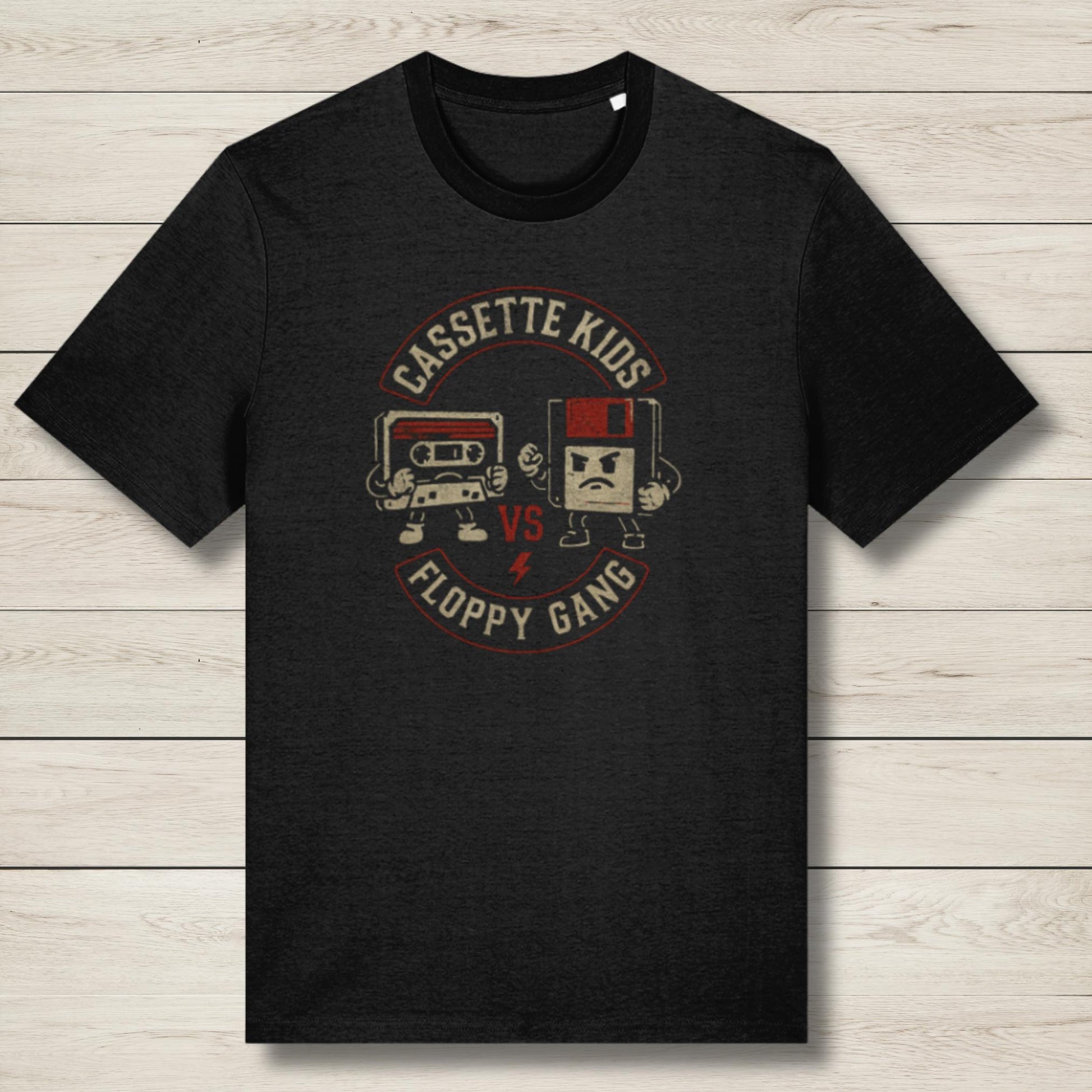 Black t-shirt with 'Cassette Kids vs Floppy Gang' graphic on a wooden surface