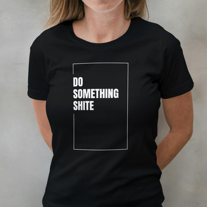 Person wearing a black t-shirt with white text 'DO SOMETHING SHITE' on a plain background