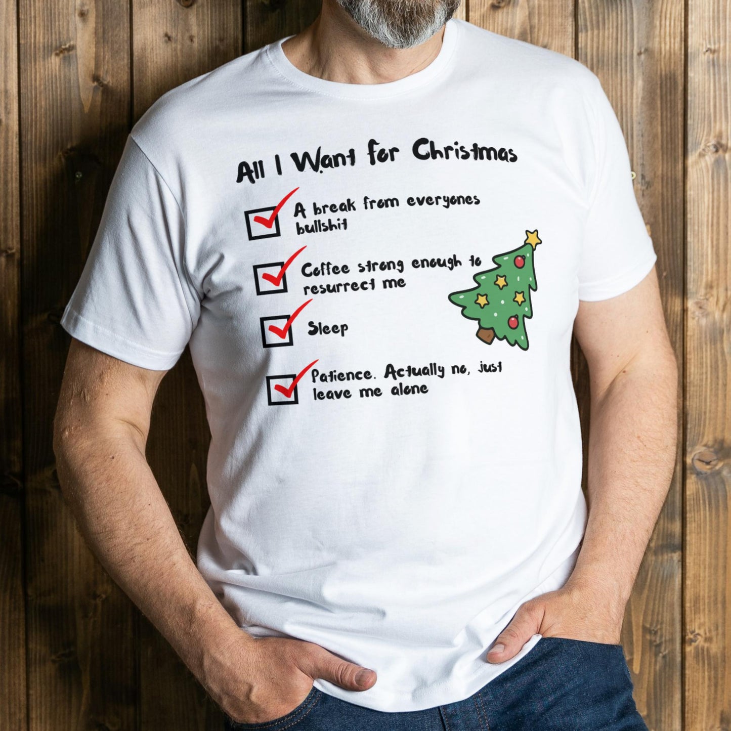 Person wearing a white t-shirt with a humorous Christmas list design against a wooden background