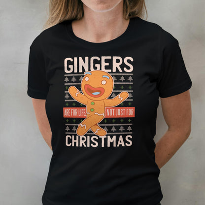 Person wearing a black t-shirt with a gingerbread man graphic and text.