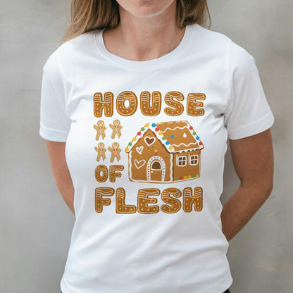 White t-shirt with a gingerbread house design and text on a plain background