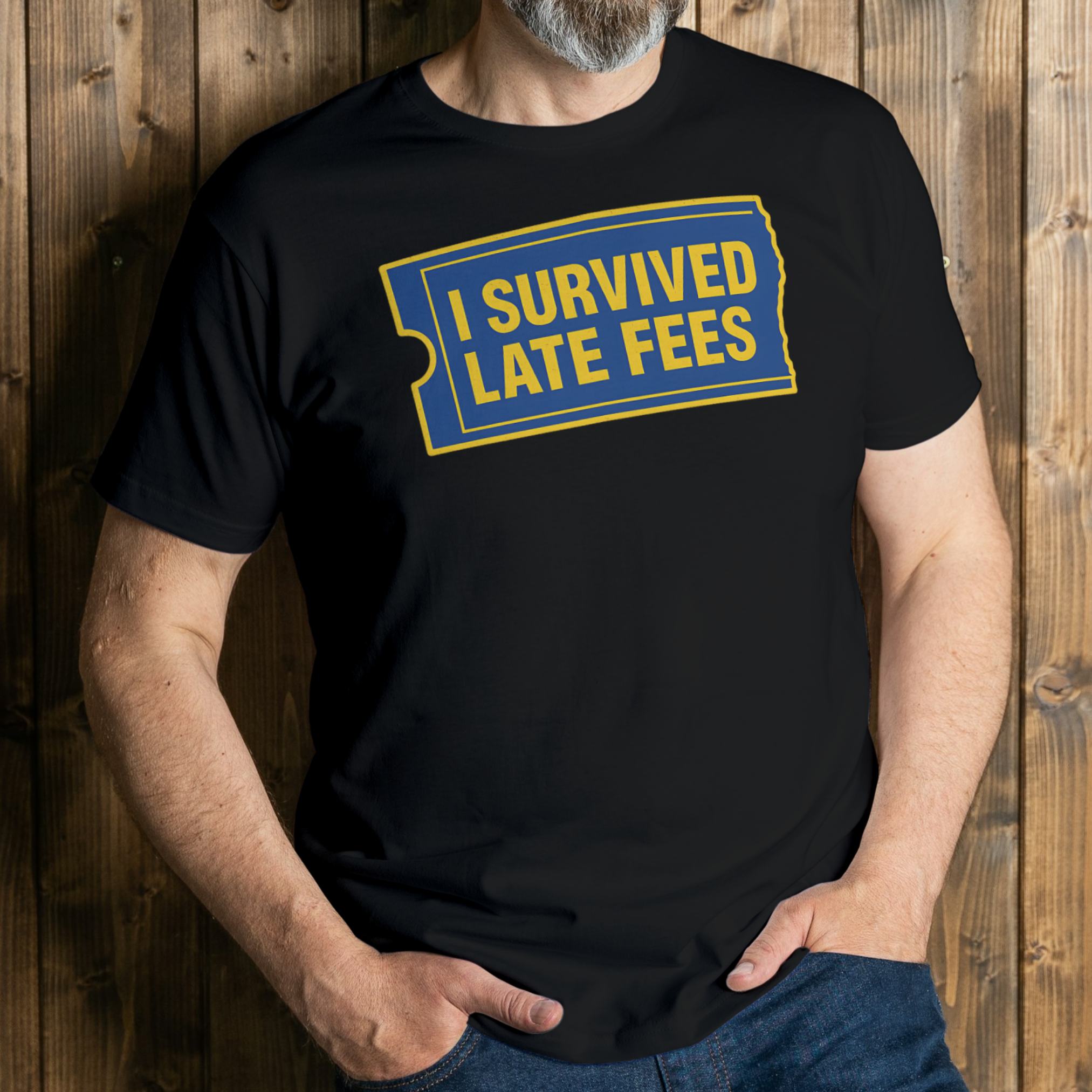 Person wearing a black t-shirt with 'I Survived Late Fees' text against a wooden background