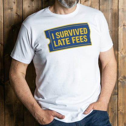 Person wearing a white t-shirt with 'I Survived Late Fees' text design on a wooden background